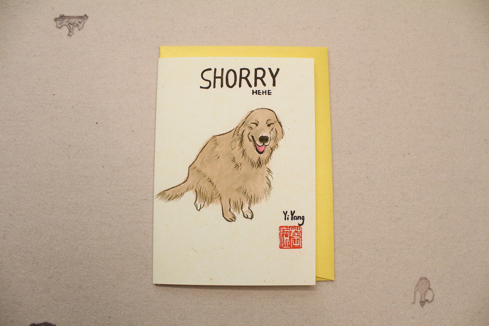 Card with a dog illustration and 'Shorry' text on a beige background
